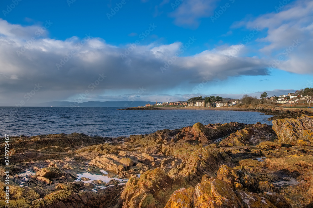Scottish Town of largs Looking Over Lichen Covered Rocks into the Town