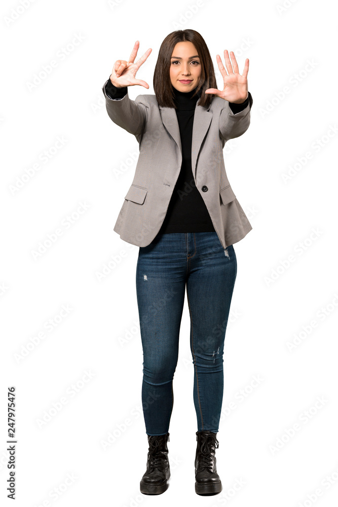 Obraz premium A full-length shot of a Young business woman counting eight with fingers over isolated white background