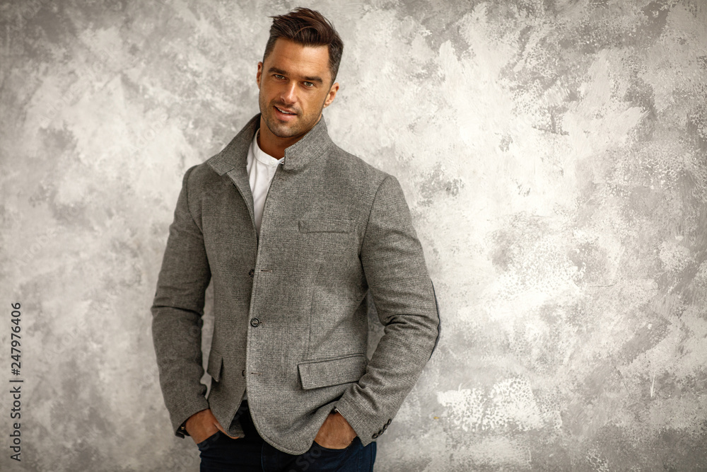 Portrait of handsome smiling man in gray stylish jacket with copy space for your text Portrait of handsome smiling man in gray stylish jacket with copy space for your text