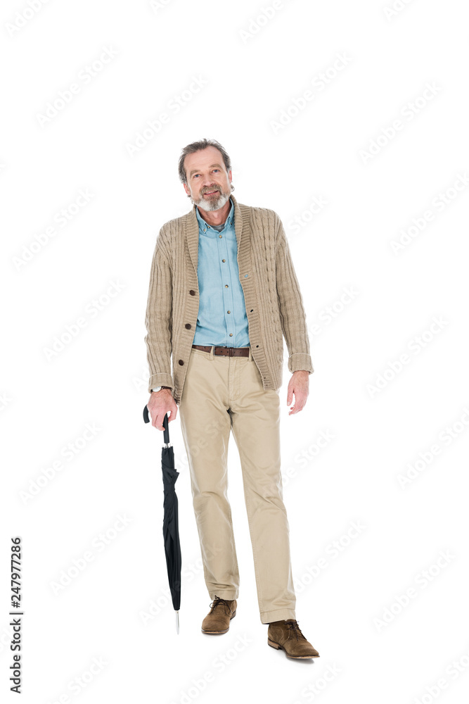 Obraz premium cheerful man holding umbrella in hand and standing isolated on white
