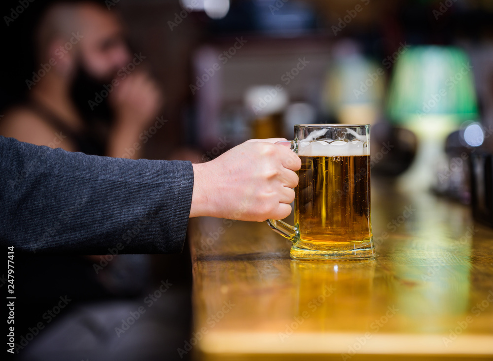 Friday leisure tradition. Beer pub concept. Weekend lifestyle. Beer mug on bar counter defocused background. Glass with fresh lager draft beer with foam. Mug filled with cold tasty beer in bar