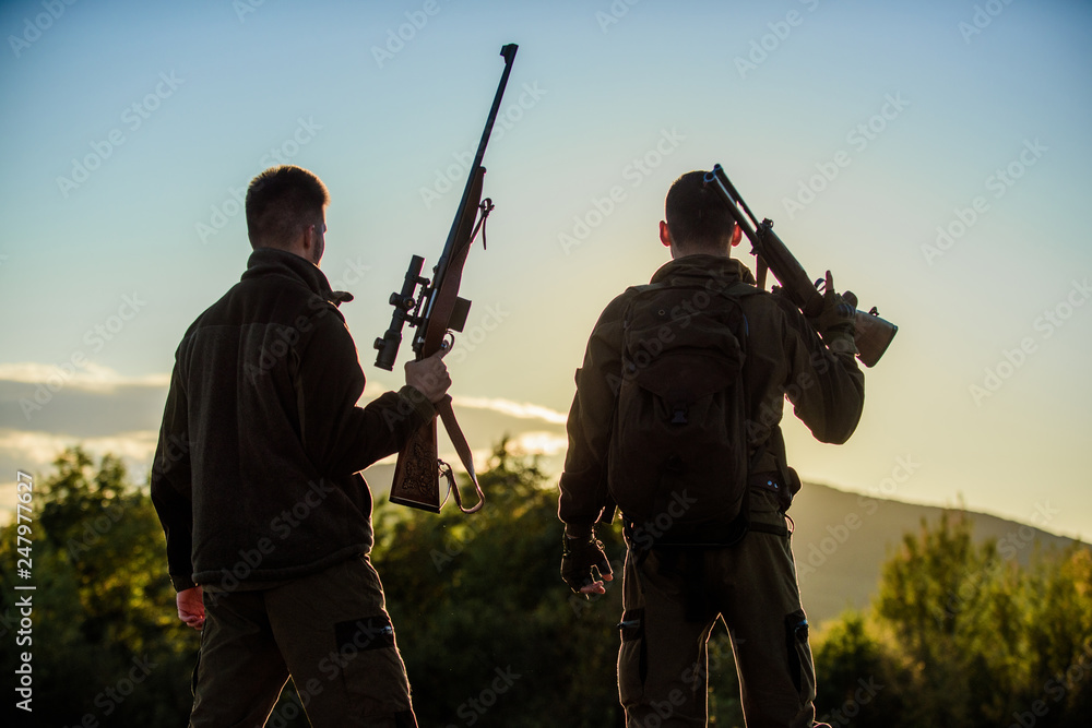 Hunters rifles nature environment. That was great day. Finish hunting season. Enjoy sunset in mountains. Hunters friends enjoy leisure. Hunters friends gamekeepers with guns silhouette sky background