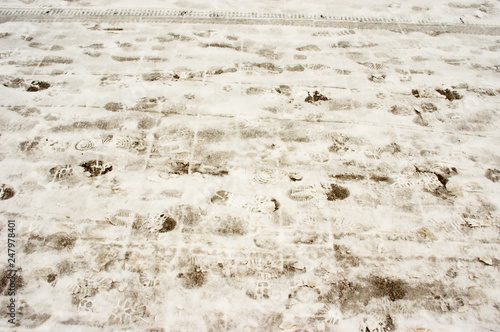 Snowy footpath with traces of human foot prints 