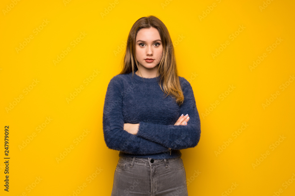 Teenager girl over yellow wall portrait Teenager girl over yellow wall portrait