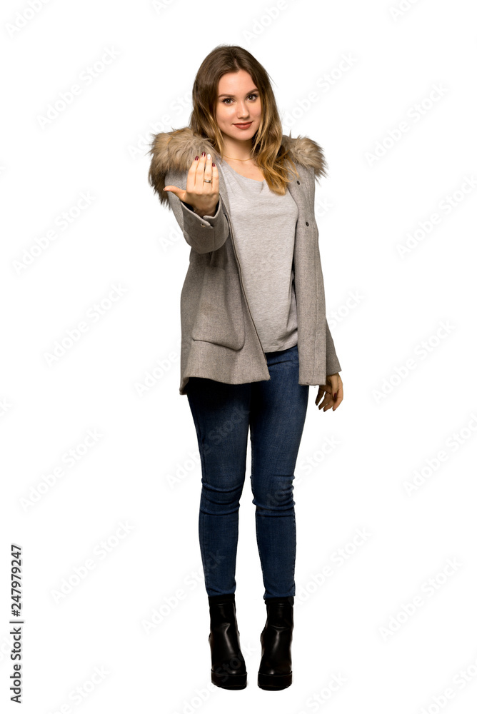 A full-length shot of a Teenager girl with coat inviting to come with hand. Happy that you came on isolated white background A full-length shot of a Teenager girl with coat inviting to come with hand. Happy that you came on isolated white background