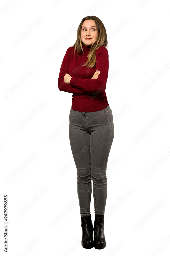 A full-length shot of a Teenager girl with turtleneck making doubts gesture while lifting the shoulders over isolated white background A full-length shot of a Teenager girl with turtleneck making doubts gesture while lifting the shoulders over isolated white background