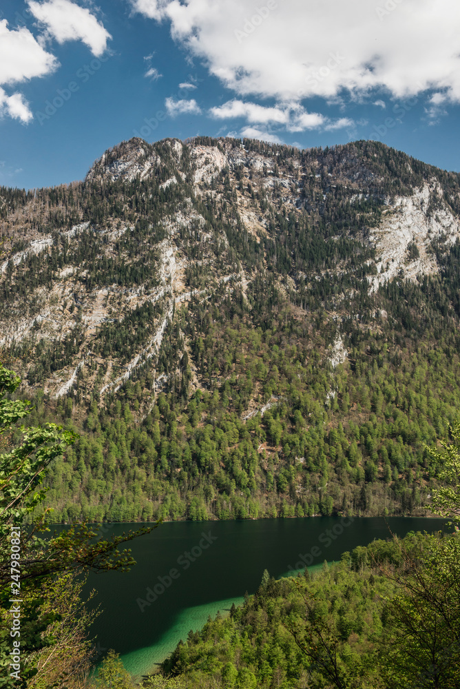Beautiful panorama on Kenigssee lake.Colorful morning view of the Bavarian Alps on the border of Austria, Germany, Europe.Photo of beautiful landscape.Green water with montains.