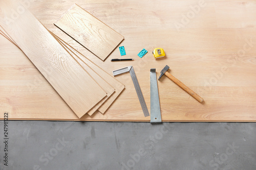 Planks of laminate floor and tools to install them