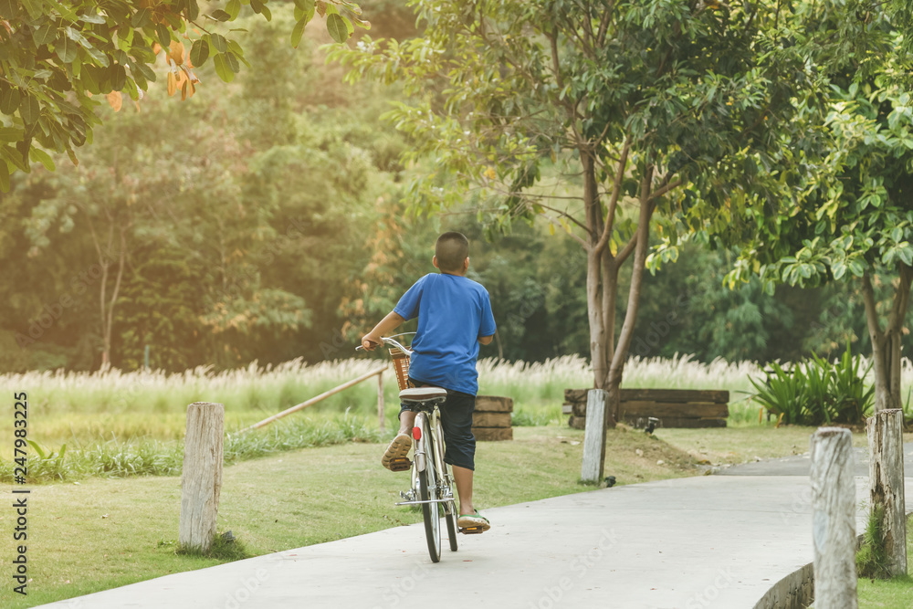 Fototapeta premium People exercising by cycling in the evening at the public park.