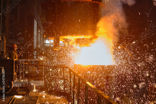 Steelmaker at ingot casting. Electric arc furnace shop EAF. Metallurgical production.