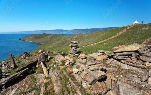 Lake Baikal. Ogoy Island. Typical for these places are stone pyramids and the Buddhist Stupa in the distance. Tourists climb to the sacred place on the hill along the path in the summer © Katvic