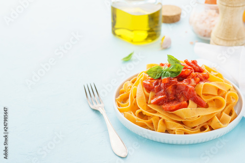 Pasta with spicy tomato sauce, bell pepper and basil for lunch