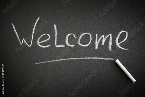 Welcome word on a blackboard. Greeting concept