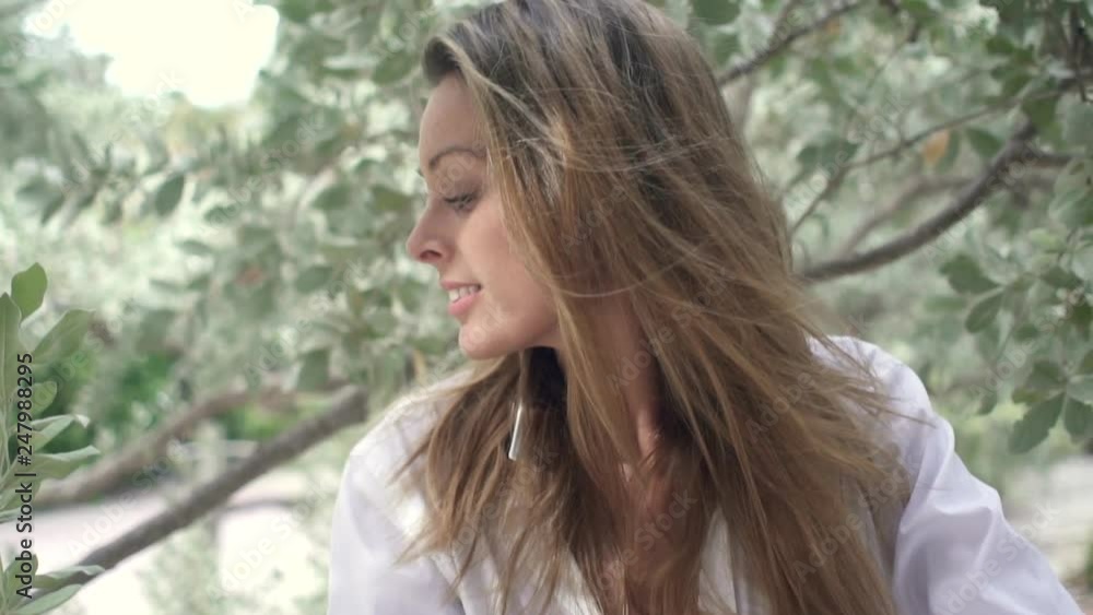 Slow motion of stunning young woman posing amongst trees Slow motion of stunning young woman posing amongst trees
