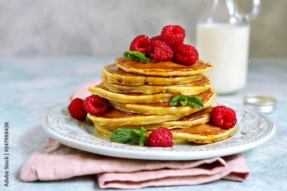 Stack of delicious homemade hot pancakes with honey and fresh raspberry. Stack of delicious homemade hot pancakes with honey and fresh raspberry.