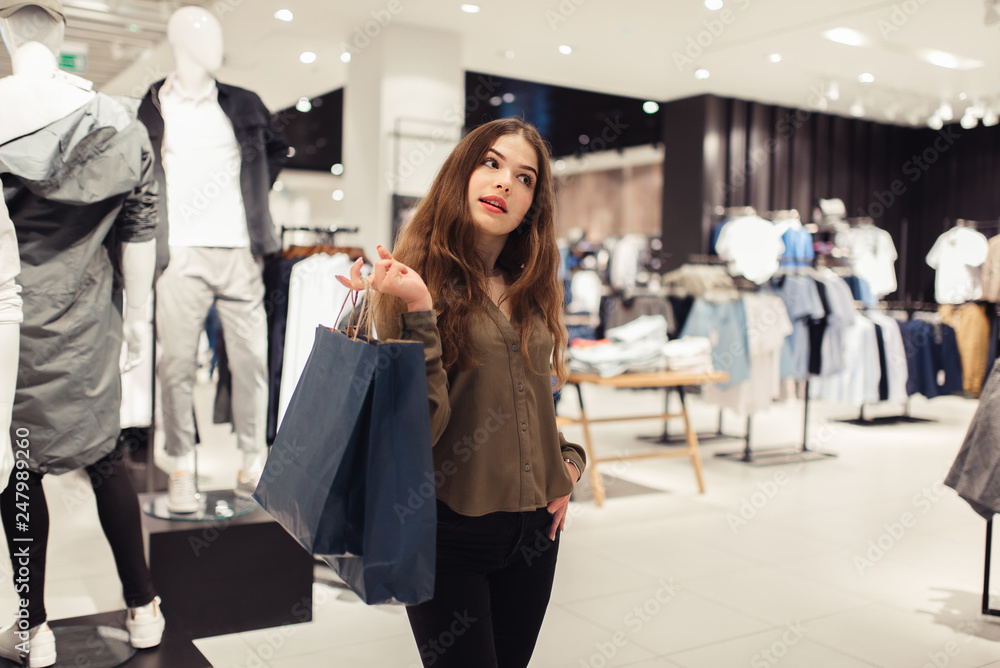 Woman in shopping. Happy woman with shopping bags enjoying in shopping. Consumerism, shopping, lifestyle concept Woman in shopping. Happy woman with shopping bags enjoying in shopping. Consumerism, shopping, lifestyle concept