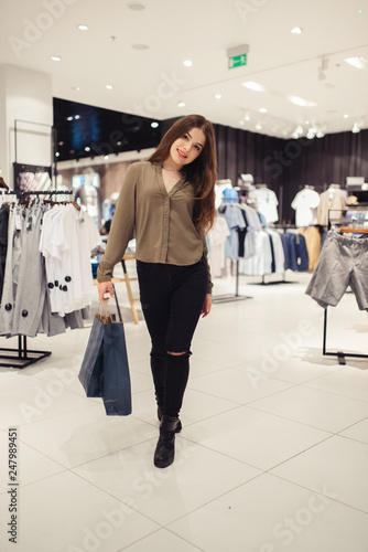 Woman in shopping. Happy woman with shopping bags enjoying in shopping. Consumerism, shopping, lifestyle concept