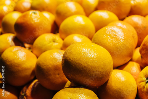 Fresh ripe grapefruits close-up in a supermarket. Citrus background