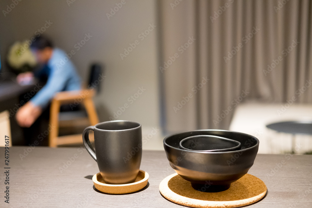 Selective focus of black bowl and cups Selective focus of black bowl and cups