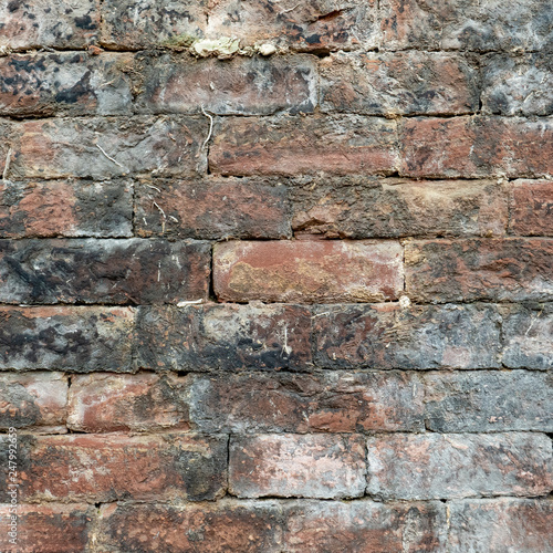 old wet brick wall in grey