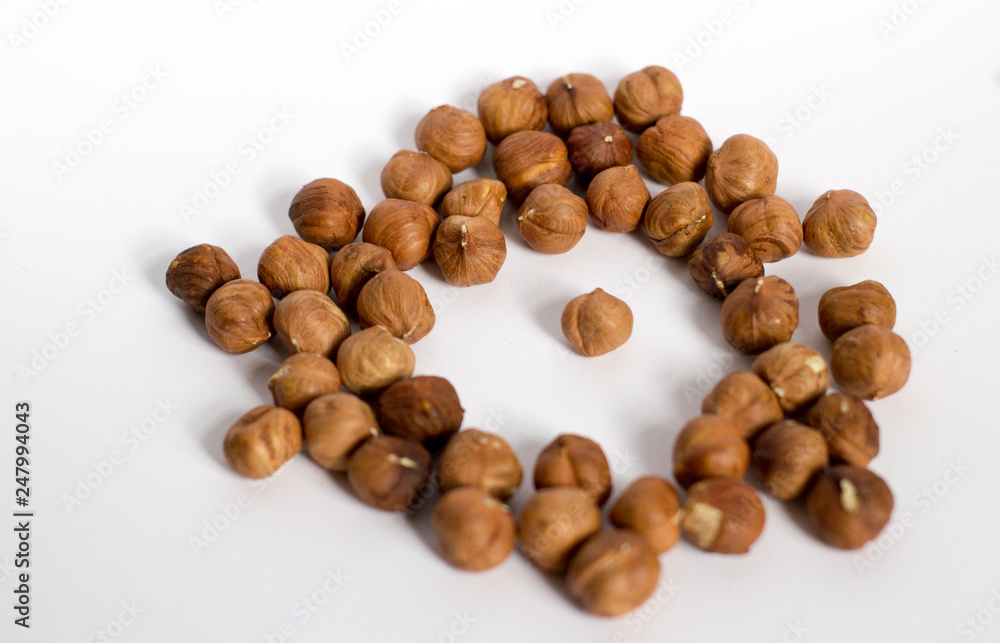handful of nuts on a white background, almonds and hazelnuts, nest handful of nuts on a white background, almonds and hazelnuts, nest