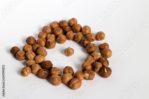  handful of nuts on a white background, almonds and hazelnuts, nest