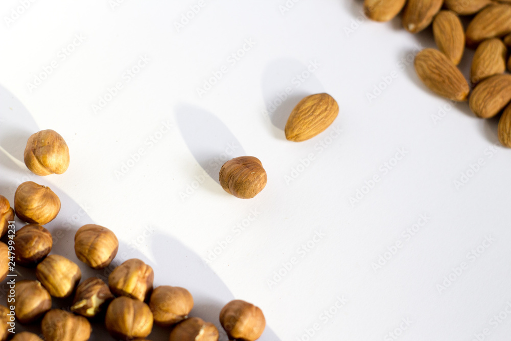 handful of nuts on a white background, almonds and hazelnuts handful of nuts on a white background, almonds and hazelnuts