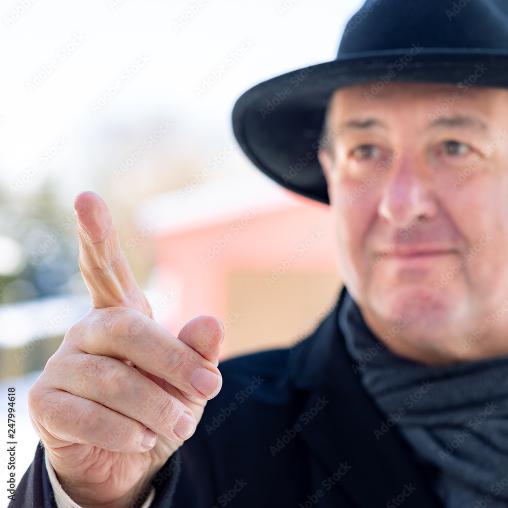 Finger pointing of man with hat Finger pointing of man with hat