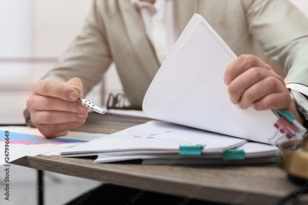 Businessman working with documents at office table, closeup Businessman working with documents at office table, closeup