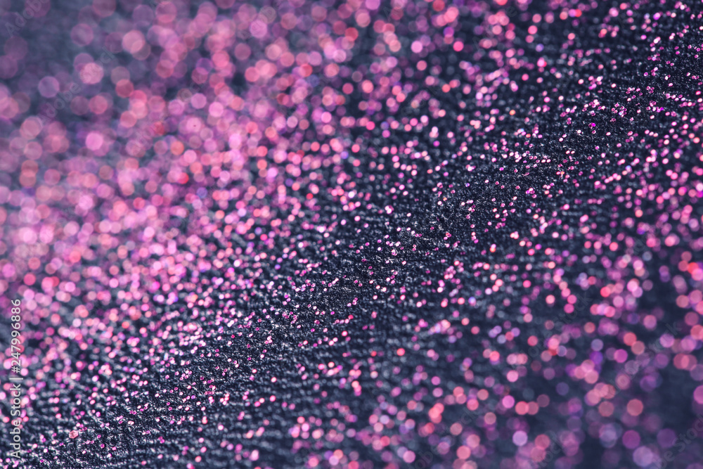 Pink glitter with bokeh effect on dark background Pink glitter with bokeh effect on dark background