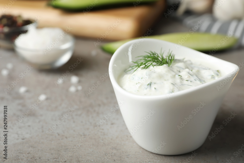 Cucumber sauce in ceramic bowl on table, space for text. Traditional Tzatziki Cucumber sauce in ceramic bowl on table, space for text. Traditional Tzatziki