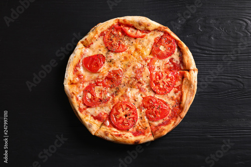 Hot cheese pizza Margherita on wooden table, top view