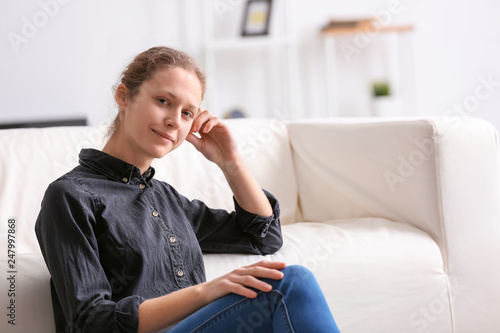 Portrait of young woman at home