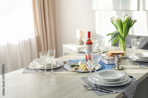Table served for Passover (Pesach) Seder indoors, space for text
