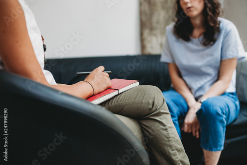 Psychotherapy session, woman talking to his psychologist in the studio photo