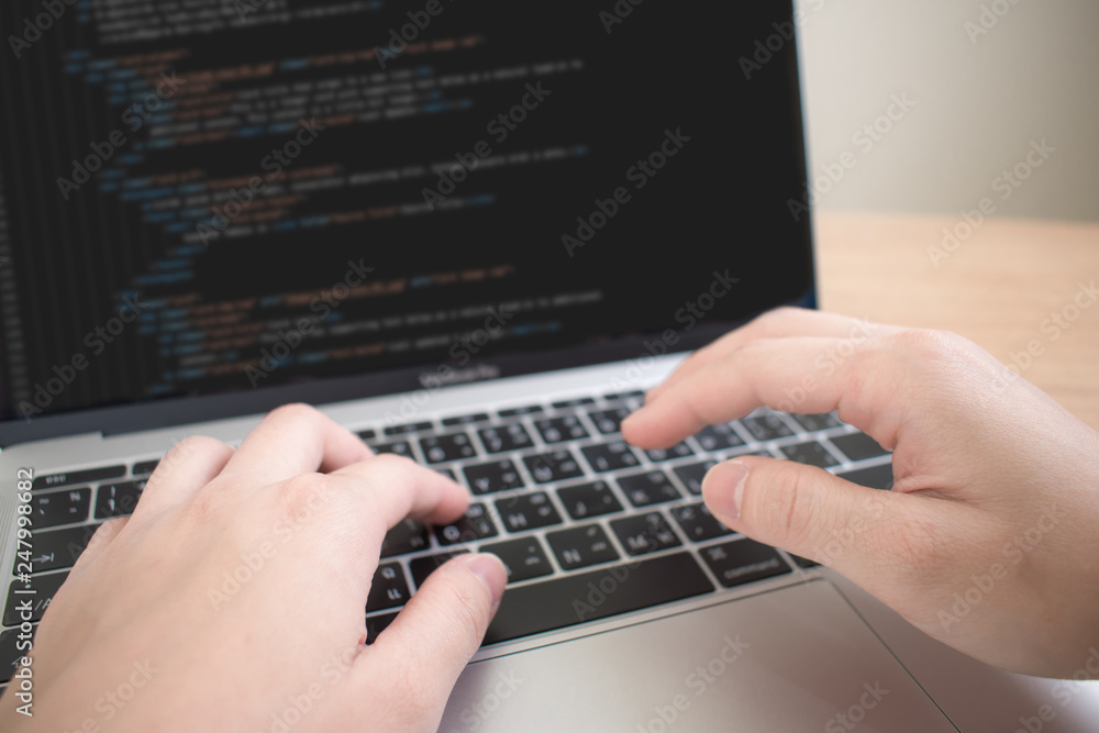 A close-up picture of a hand that is working in a programmer to create some systems. A close-up picture of a hand that is working in a programmer to create some systems.