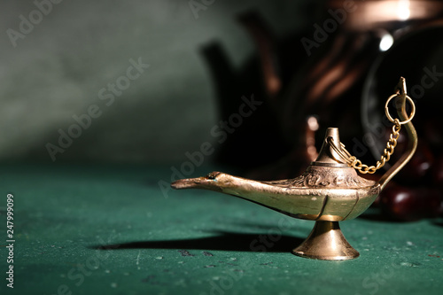 Aladdin lamp of wishes on color table