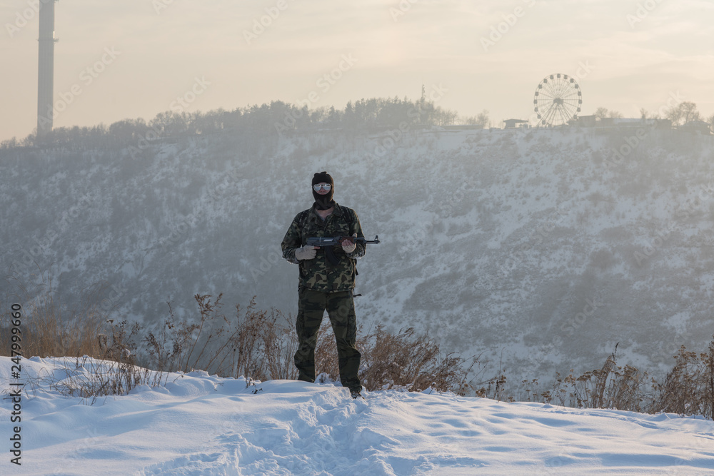 military with a gun on the mountain in winter, military operation