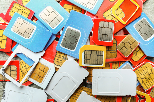 Plakat Many sim cards on grey background, closeup