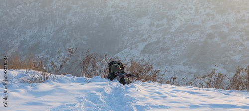 sniper, soldier with a gun hiding in the bushes, winter