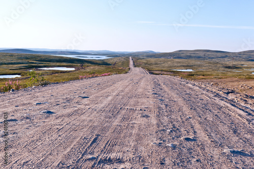 The dirt road in the tundra in northern Russia