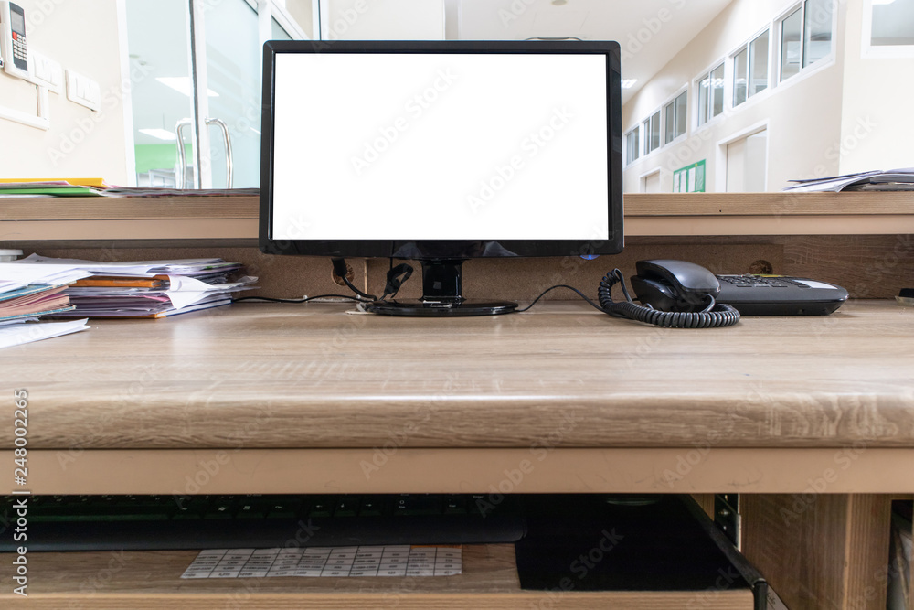 Fototapeta premium Monitor computer with blank screen on wooden desk in office.