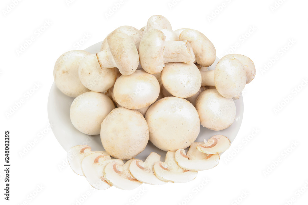 pile of champignon mushrooms on a plate isolated on white background pile of champignon mushrooms on a plate isolated on white background