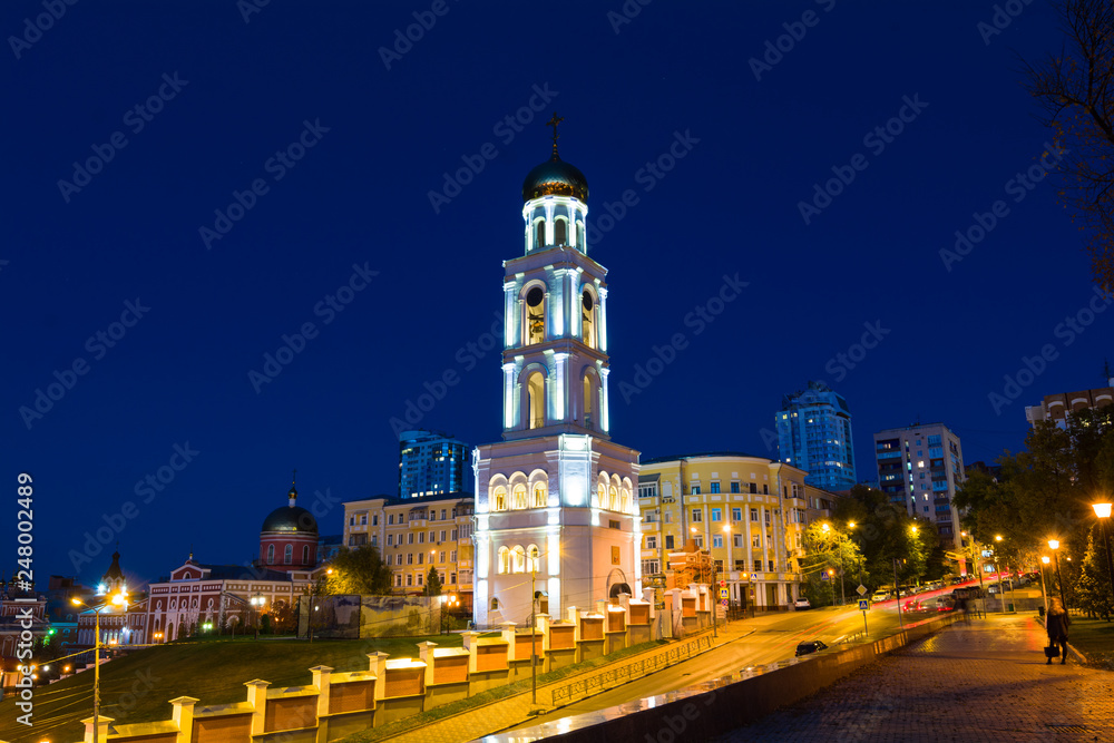 The night picture of beautifully lit white church with gold domes.
