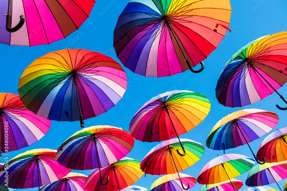 Many colorful umbrellas. Rainbow gay pride protection - obrazy, fototapety, plakaty 