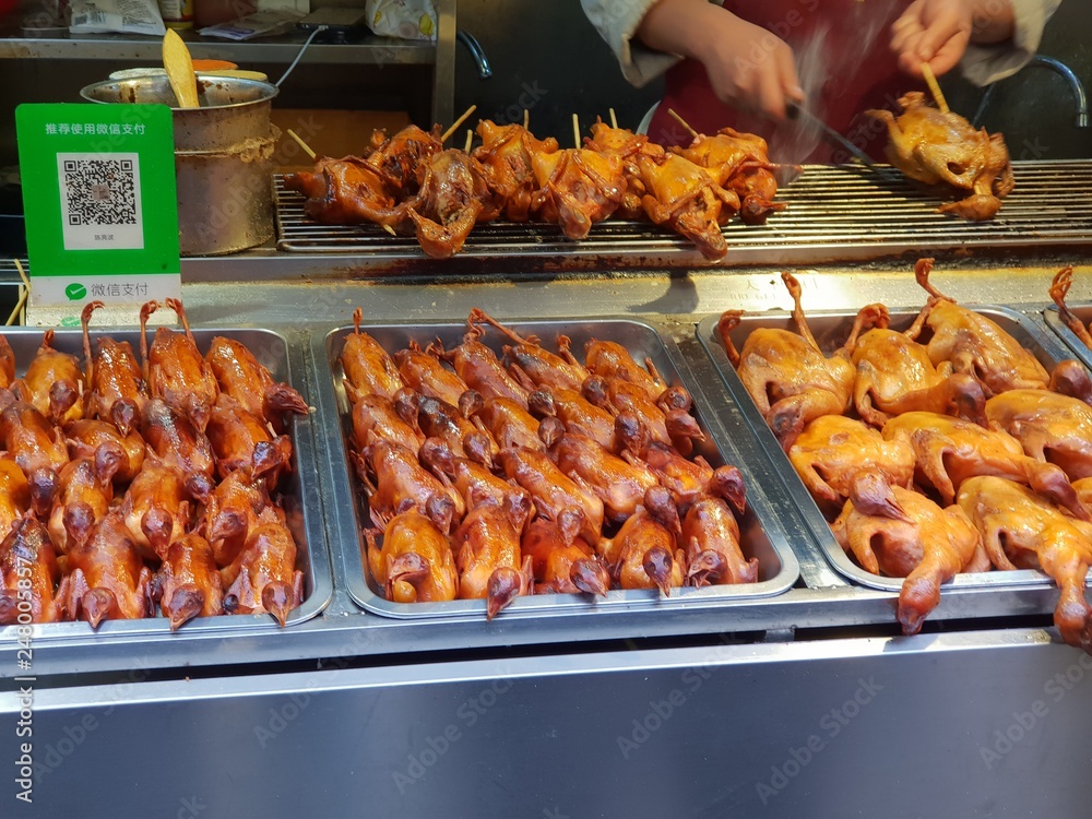 Grilled little ducks at a local Chinese market in Beijing
