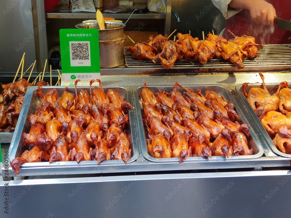Grilled little ducks at a local Chinese market in Beijing