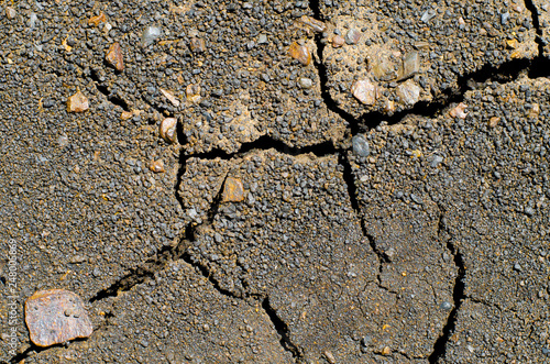 Fotografie Cracks and fissures in the dry earth create beautiful, richly textured images