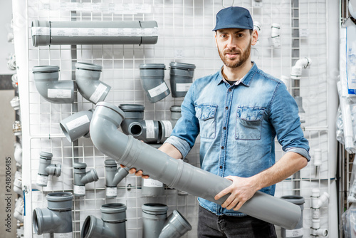 Man choosing pipes in the plumbing shop