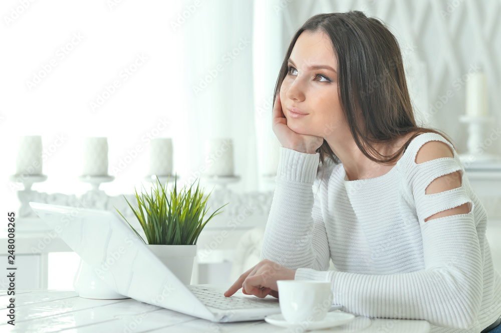 Portrait of young woman using modern laptop at table Portrait of young woman using modern laptop at table